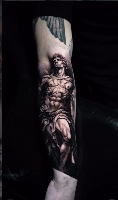 Realism Saint Sebastian statue tattoo on forearm